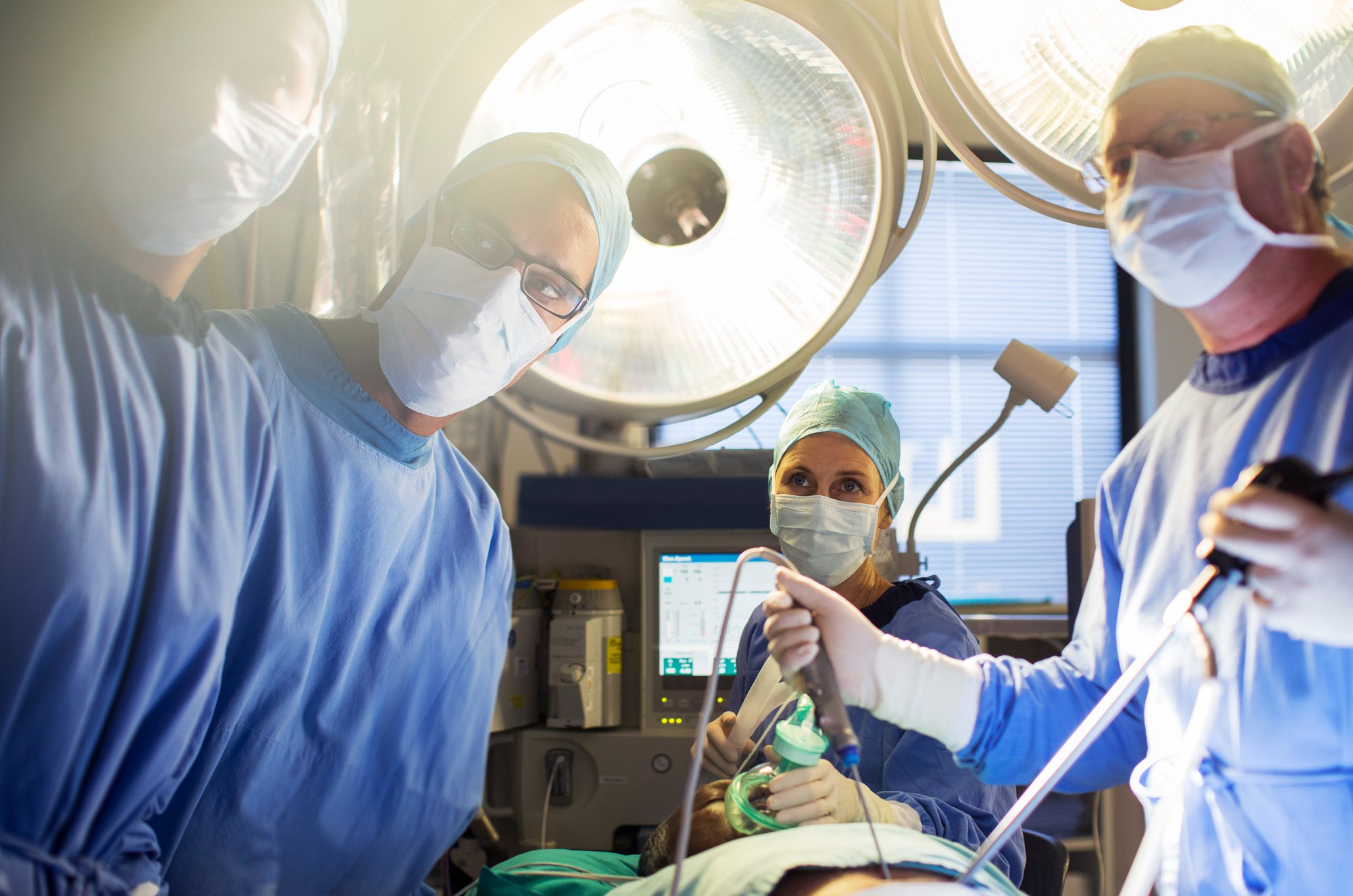 Team of doctors performing laparoscopic surgery in operating theater